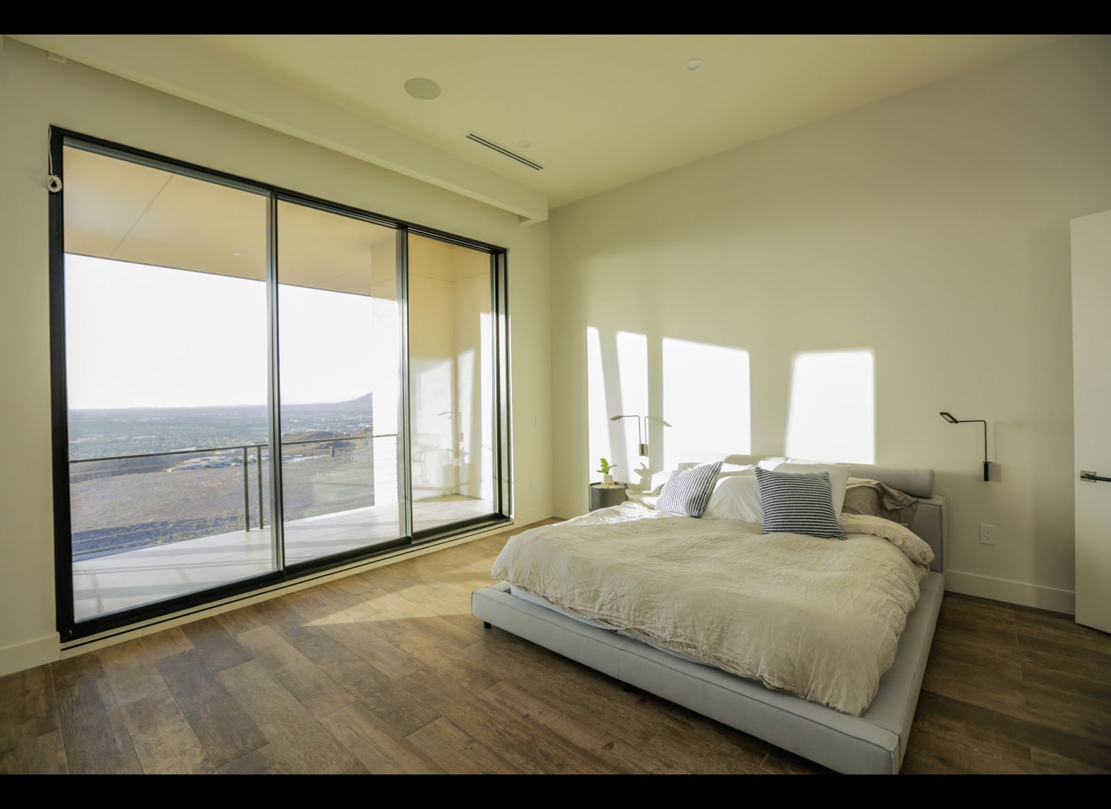 Bedroom with upholstered bed facing the valley