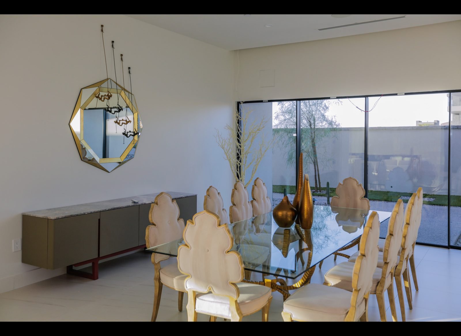 Dining room with sculpted chairs and glass table