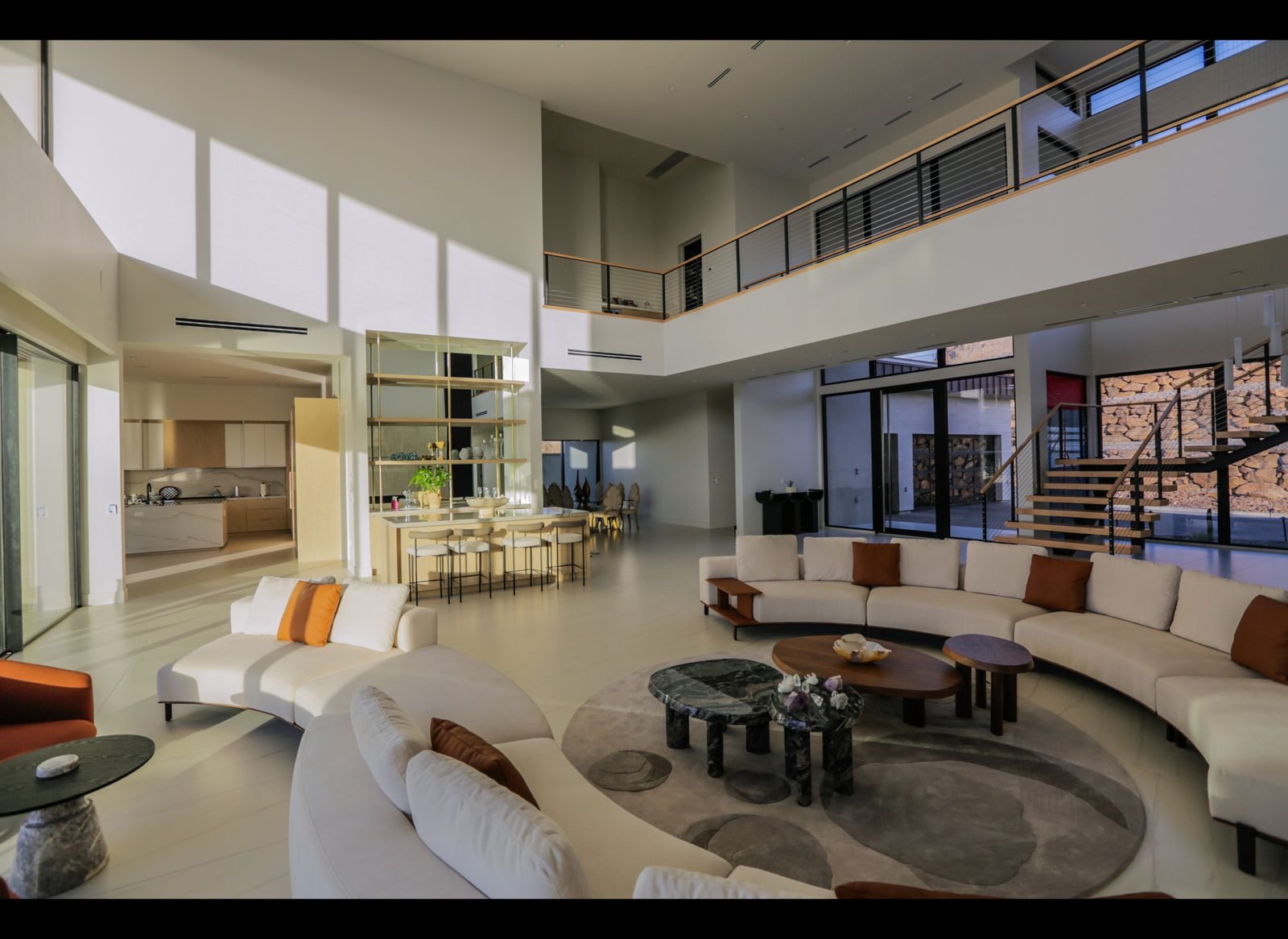 Living room with curved sectional and round coffee tables