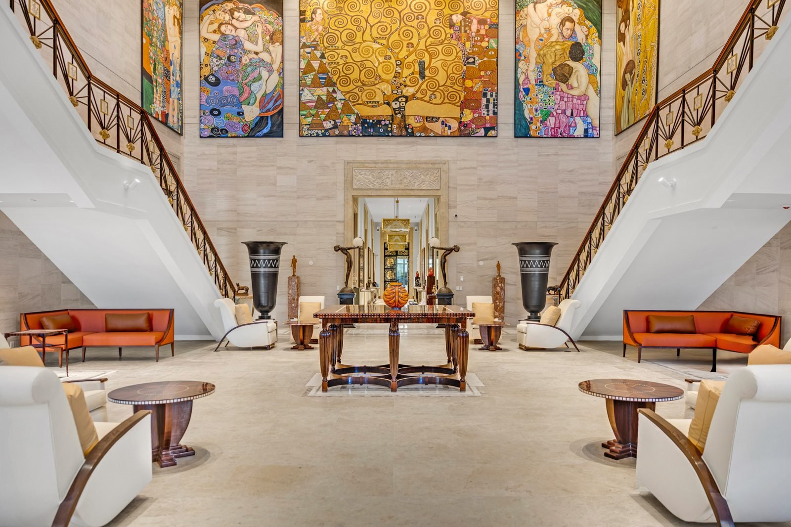 Grand stair hall with curved staircases and lounge seating